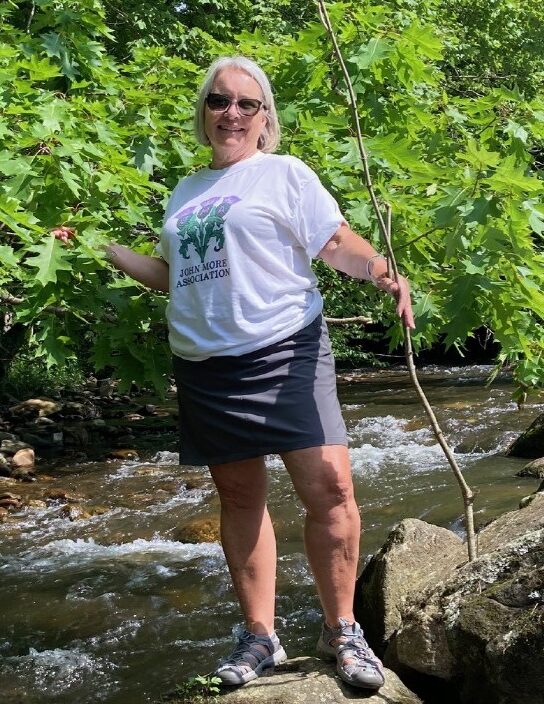 Photo of Patty Yewcic (President) in a stream.