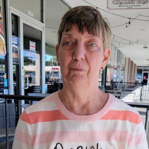 Portrait of Juanita Goin in pink striped shirt. Photo provided in 2025