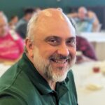 Portrait of Joe Klett in green polo taken in 2025. Photo provided in 2025