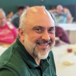 Portrait of Joe Klett in green polo taken in 2025. Photo provided in 2025